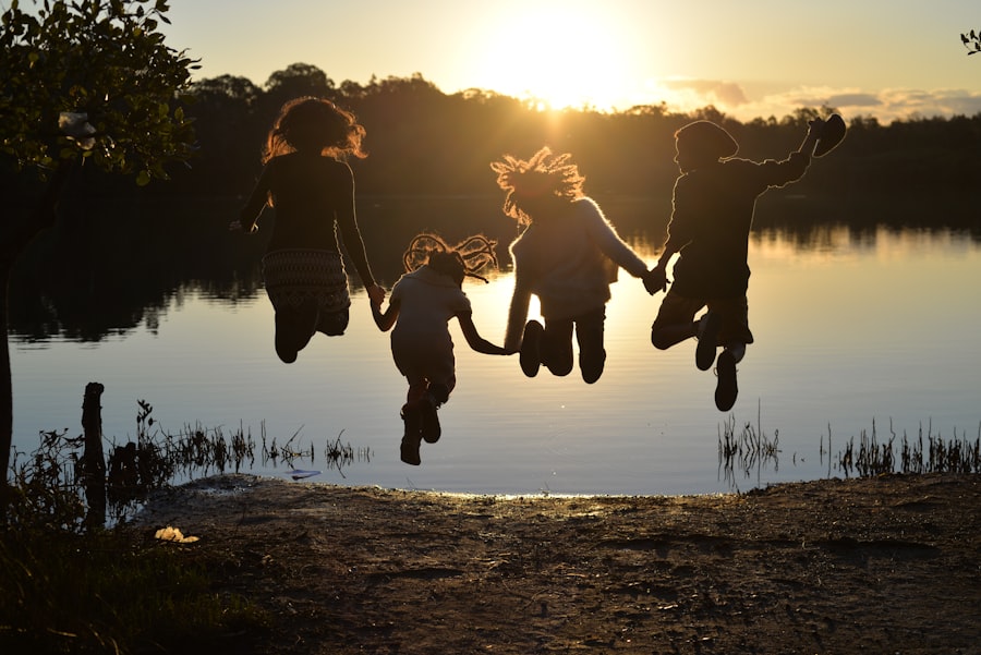 A group of kids jumping into the air together outside on a bright day